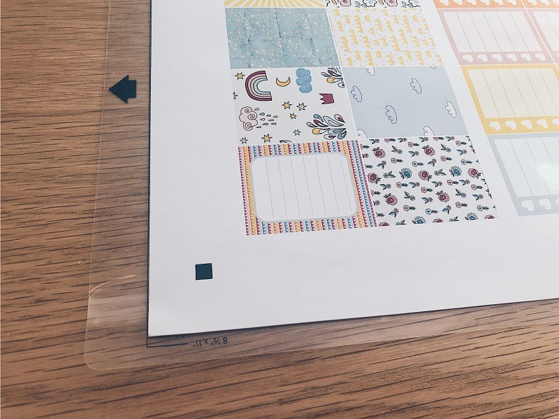 Cutting mat with sticker design on top